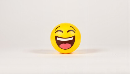 Fototapeta premium Joyful laughing emoji on plain background, symbolizing happiness