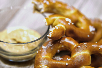 Closeup with eating pretzels and mustard