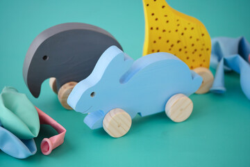 Vibrant and Colorful Wooden Animal Toys Accompanied by Cheerful Balloons