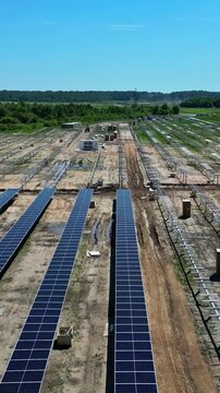 Rows of solar panels being installed at a large solar park under construction