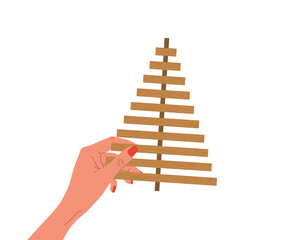 Obraz premium Handmade Christmas Tree. Female hand holding Christmas tree made of wooden planks. Zero waste holiday ornaments. Ecological seasonal decoration. Vector illustration in flat cartoon style.