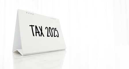 ext Tax 2025 on the desk calendar. Business and Annual tax concept.