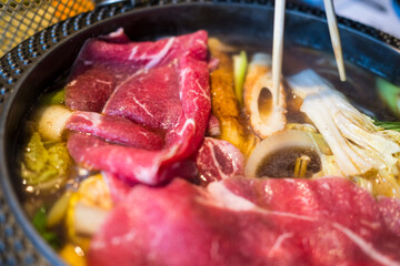 Traditional Sukiyaki pot with raw premium beef and fresh vegetable