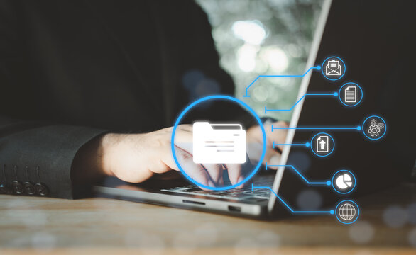 Businessman using a computer to document management concept, online documentation database and digital file storage system or software, records keeping, database technology, file access, doc sharing.