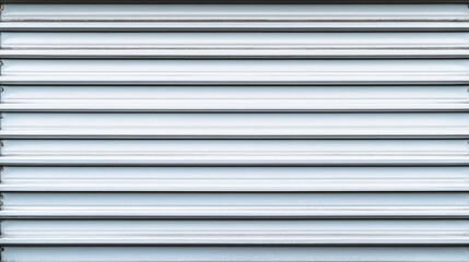 Obraz premium Close-up of a modern, sleek metallic roller shutter design for industrial use.