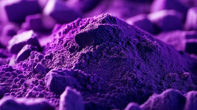Detail of vibrant purple powder on a textured surface exhibiting unique granulation under soft lighting
