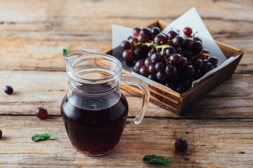 Grape juice on wooden background