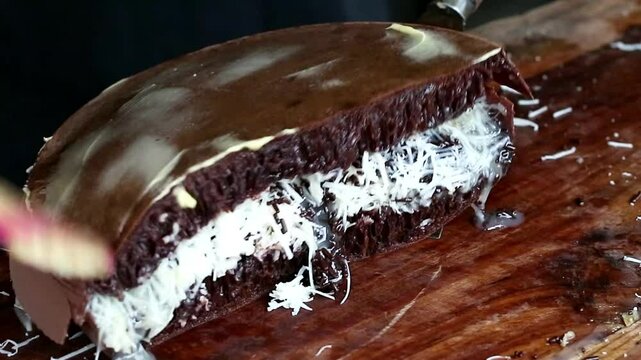 Asian Indonesia man's hand cooking street food terang bulan with nuts, chocolate, cheese, milk. entrepreneurship idea. empowerment concept. Popular pancake sweet street food  in Indonesia. 