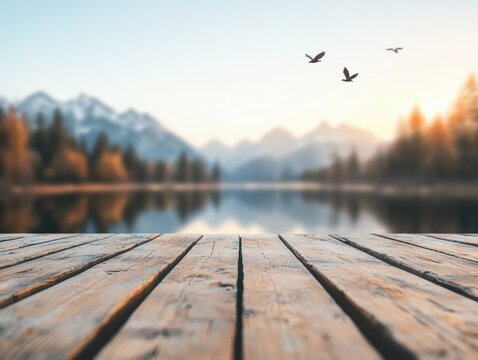 Empty wooden table overlooking serene mountain lake with birds flying