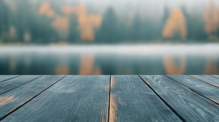 Obraz premium Empty wooden table by lake with distant ducks, early mist, cozy and peaceful outdoor setting
