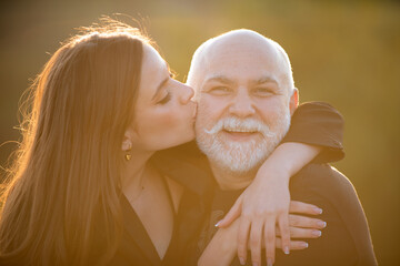 Senior old man and daughter. Sexy lady with sugar daddy, close up portrait. Senior grandad and...