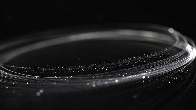 Illuminated circular lines on a dark background depicting digital technology and motion with floating particles in a space of emptiness