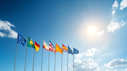 Obraz premium Colorful international flags waving under a bright sky with soft clouds showcasing unity and diversity among nations and regions representing global cooperation and identity.