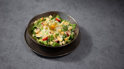 Cesar salad with cheese and cherry tomatoes