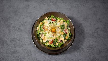 Cesar salad with cheese and cherry tomatoes
