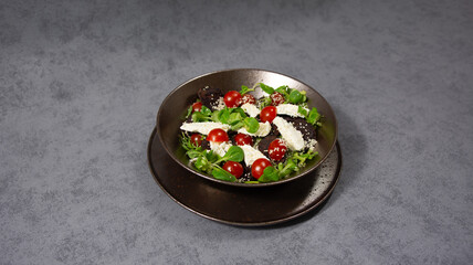 Fresh salad bowl, with cherry tomatoes and white cheese