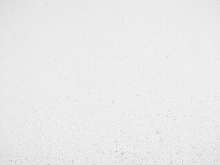 Mud splashed on a white cement wall. Mud drops on concrete surface