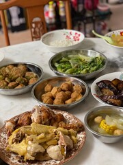A simple home-style reunion dinner for Chinese New Year, featuring traditional dishes on table, symbolizing unity and togetherness.