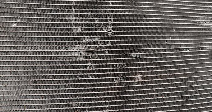 car radiator made of lead damaged after an accident, a radiator damaged in an accident to cool the car during engine operation