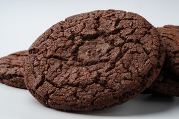 Deliciously baked chocolate cookies arranged on a clean white surface ready to be enjoyed