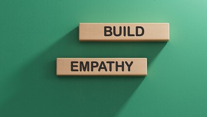 Obraz premium Build empathy symbol. Wooden blocks with words Build empathy.Psychology and Build empathy concept. Copy space.3D rendering on green background.