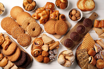 Variety of baked goods displayed on wooden surfaces, including cookies, pastries, and sweet treats...