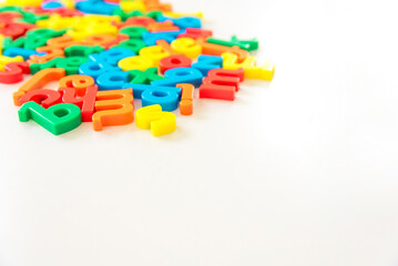 Colorful random English letters scattered on white isolated background and copy space. Communication, speech, writing, words, say, talking, reading, literature, learning concept. Latin alphabet.