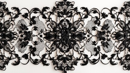 Elegant black lace designs with a symmetrical motif on a neutral white surface, showcasing fine detail.