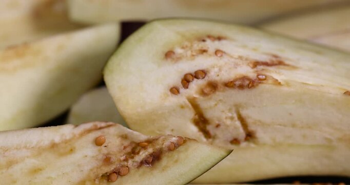 sliced lengthwise ripe eggplant during cooking, the flesh and seeds of sliced ripe eggplant