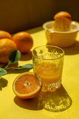Freshly squeezed orange juice in a glass. Oranges. Vitamins.