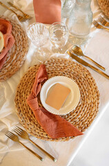 woven placemat settings with burnt orang napkins