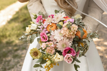 groom holding wedding bouquet with bride