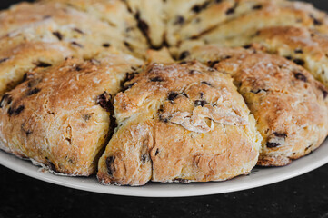 Orange, chocolate chip scones with on a black countertop