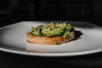 Avocado toast in dramatic lighting