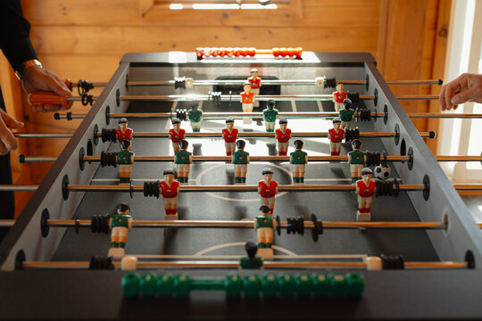 guys hanging out playing foosball inside