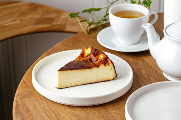cheesecake on a plate with tea
