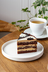 piece of chocolate cake on a plate with tea