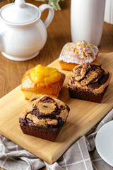 assorted cupcakes on a board