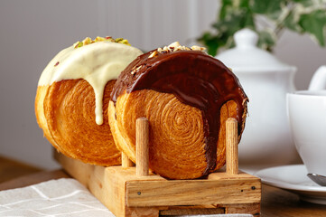 round croissant with icing on a stand