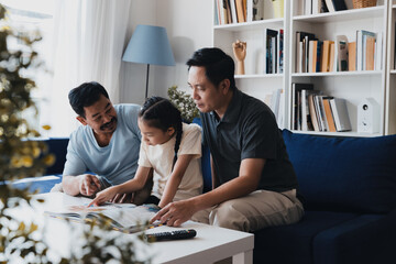 Loving LGBTQ couple sharing a storytime moment with their adopted child in a cozy living room