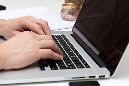 close-up of Hands Typing on a Laptop Keyboard