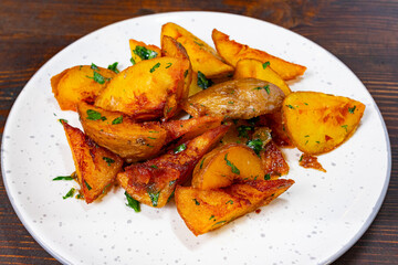 Crispy roasted potatoes served with fresh herbs on a white plate Savory vegetable pie served with fresh garnishes on a white plate