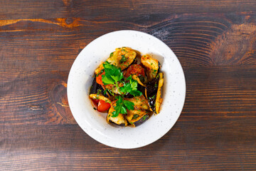 Flavorful vegetable dishin a white bowl on wooden table Savory vegetable pie served with fresh garnishes on a white plate