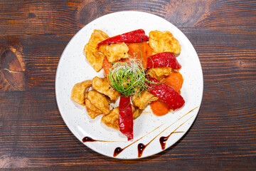 Colorful dish with chicken and vegetables served on a white plate Savory vegetable pie served with fresh garnishes on a white plate