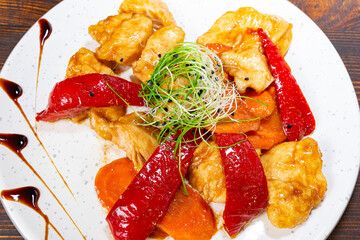 Delicious chicken stir-fry with colorful vegetables on a plate Savory vegetable pie served with fresh garnishes on a white plate