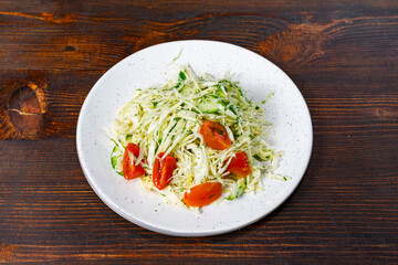Fresh garden salad with tomatoes and cucumbers served on a plate Savory vegetable pie served with fresh garnishes on a white plate