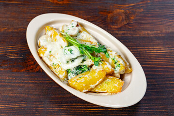 Delicious creamy vegetable dish served in a bowl on a wooden table Savory vegetable pie served with fresh garnishes on a white plate