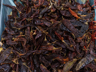 Guajillo chili on supermarket shelves.Variety of chili peppers on supermarket shelves in Mexico