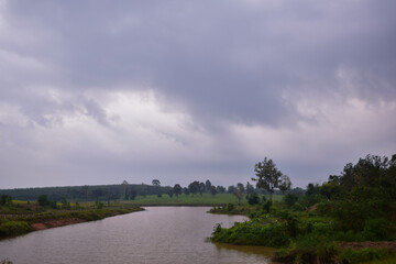 Dramatic sunset sky with clouds, picturesque field and scenic road, Russian landscape. Sky and clouds