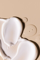 samples of cosmetic care products smear of cream texture on a beige background